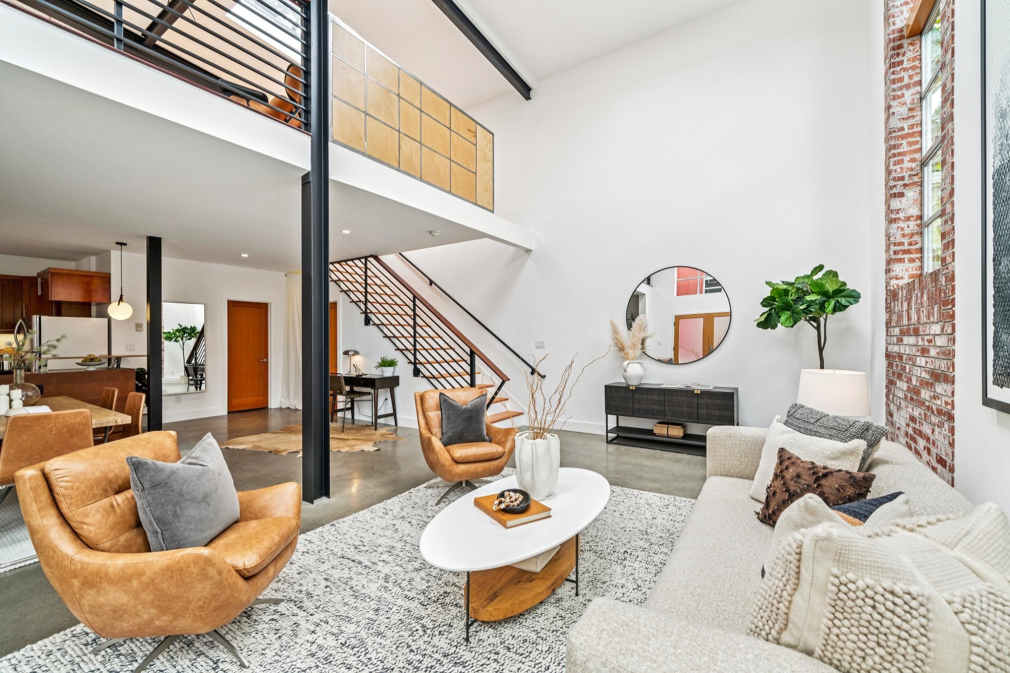 829 21st Street, Unit 3 Oakland, CA 94607 - Photo 4 of 47 Living room featuring a high ceiling and finished concrete floors