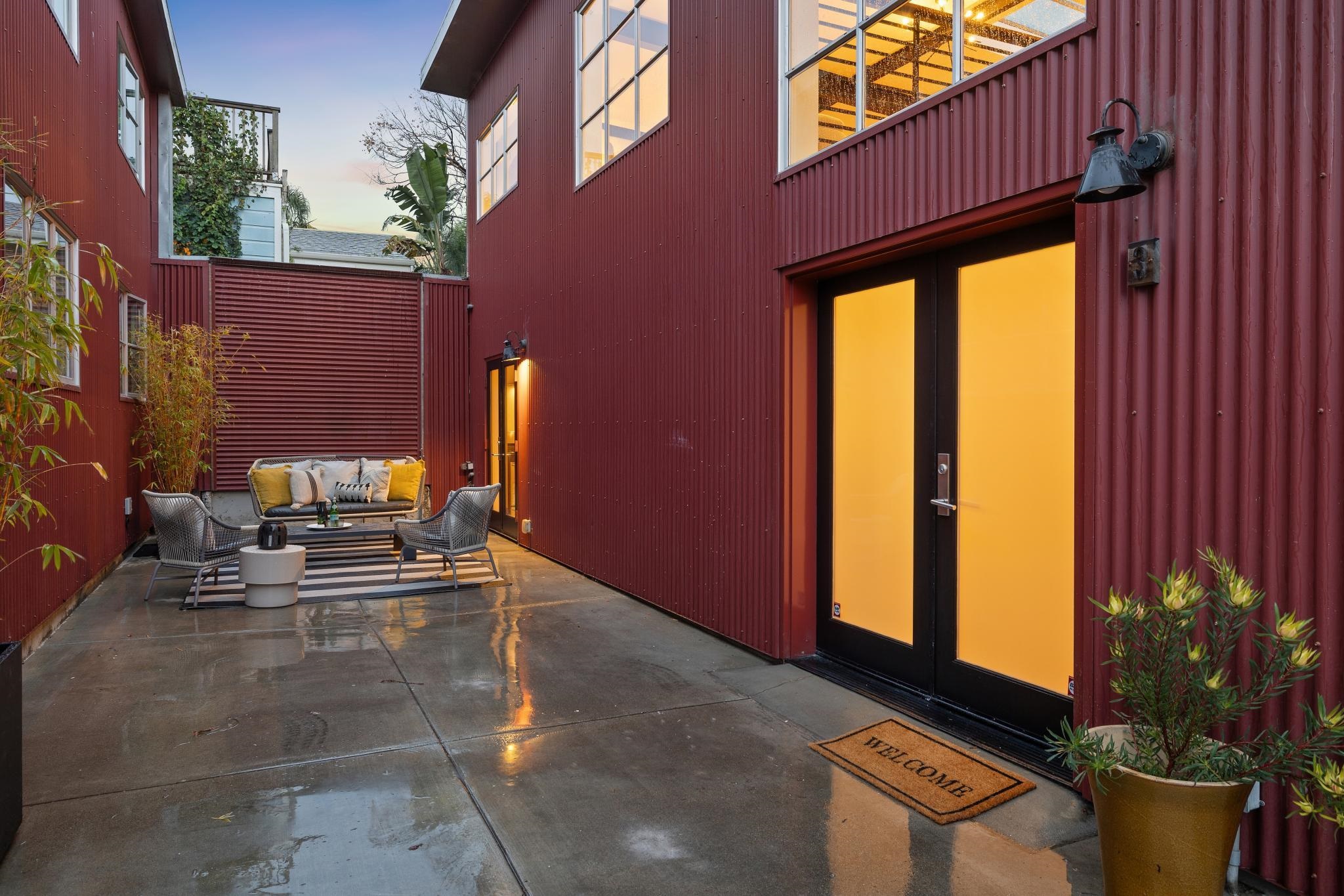 829 21st Street, Unit 3 Oakland, CA 94607 - Photo 45 of 47 Patio terrace at dusk with french doors, an outdoor hangout area, and a patio