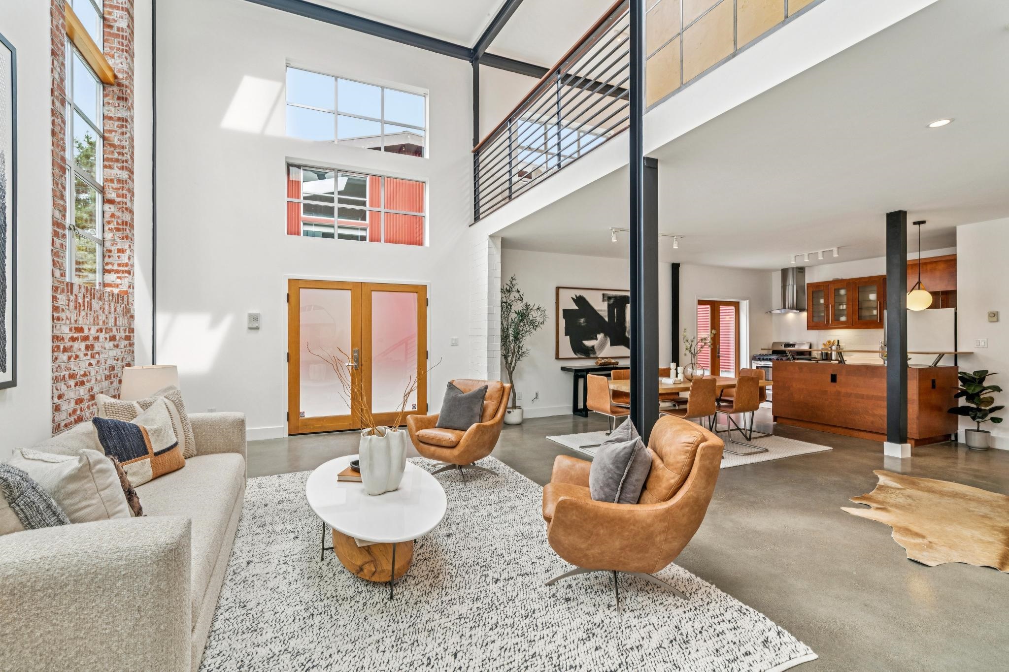 829 21st Street, Unit 3 Oakland, CA 94607 - Photo 6 of 47 Living room with finished concrete flooring, a high ceiling, and french doors