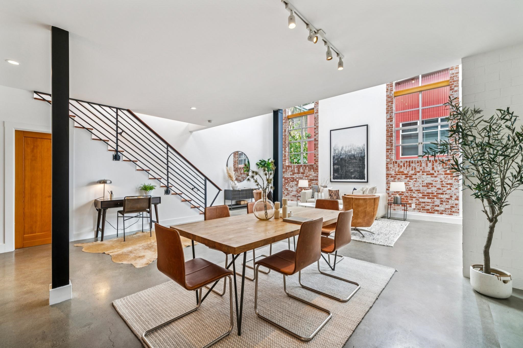 829 21st Street, Unit 3 Oakland, CA 94607 - Photo 8 of 47 Dining room with concrete floors and brick wall