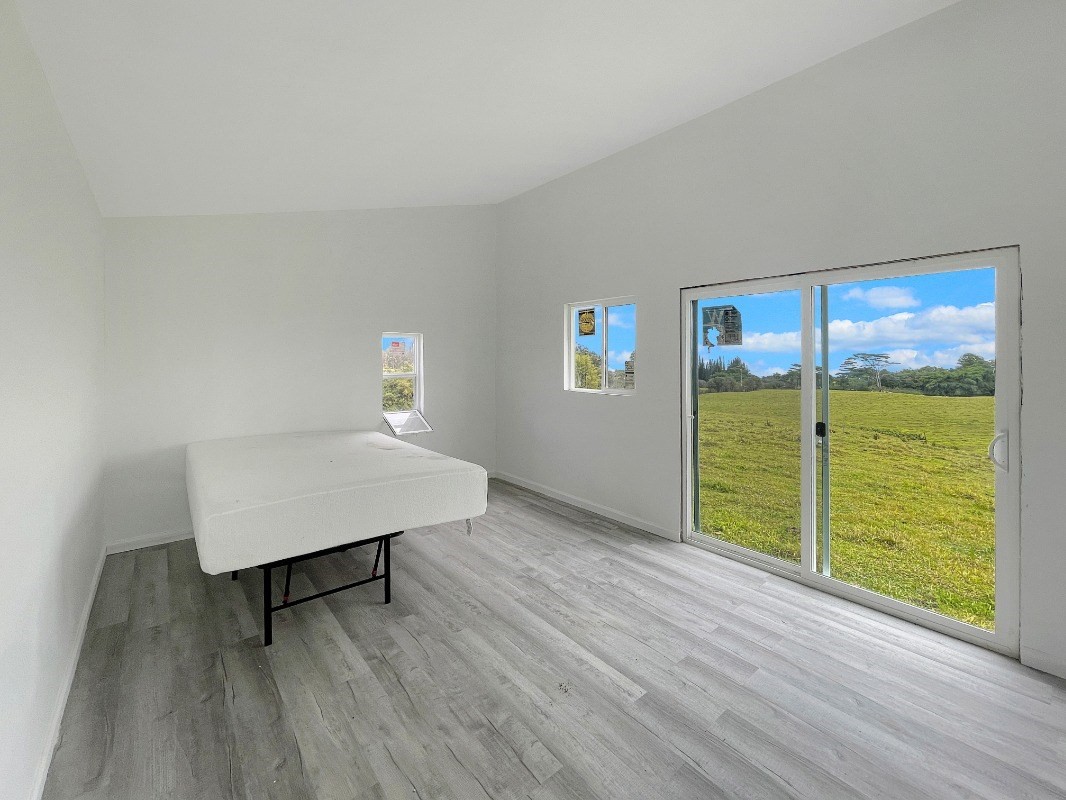 36 B Kaiwiki-Homestead Road Papaikou, HI 96781 - Photo 11 of 12 a room with wooden floor and a window