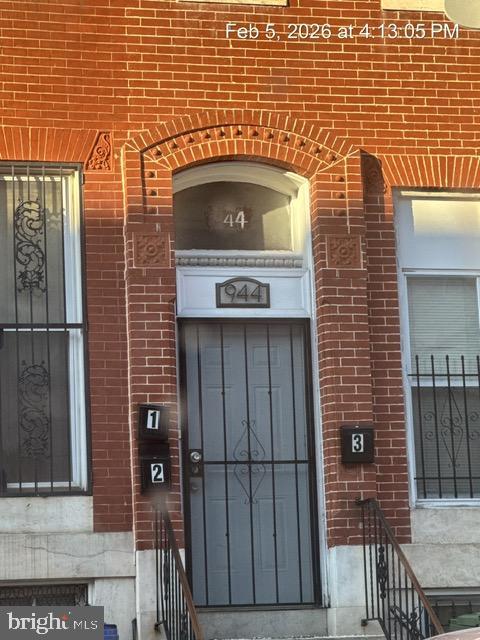 944 Harlem Avenue Baltimore, MD 21217 - Photo 2 of 9 a front view of a building with a door