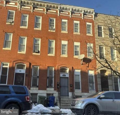 944 Harlem Avenue Baltimore, MD 21217 - Photo 3 of 9 a couple of cars parked in front of a building