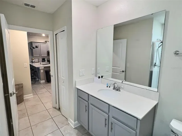 a bathroom with a sink vanity and a mirror