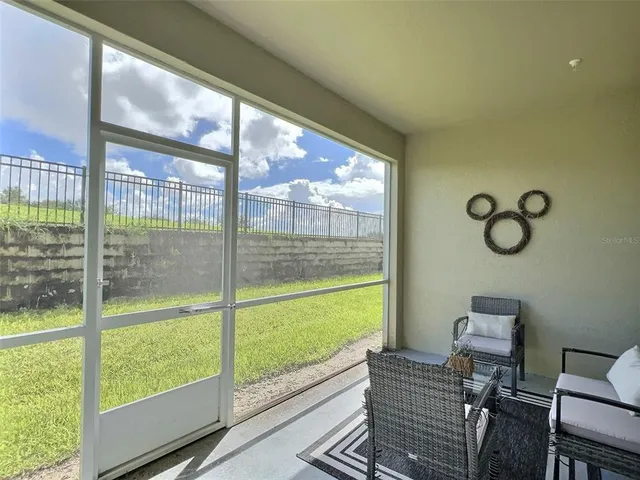 a view of a living room and floor to ceiling window or wooden floor