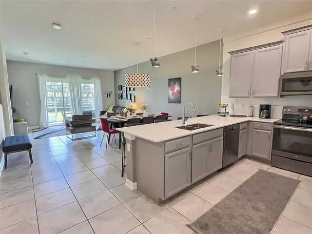a kitchen with a sink stove and cabinets