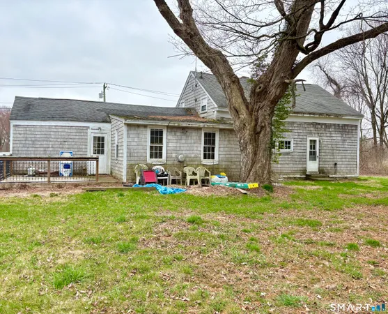 a view of a house with a yard next to a road
