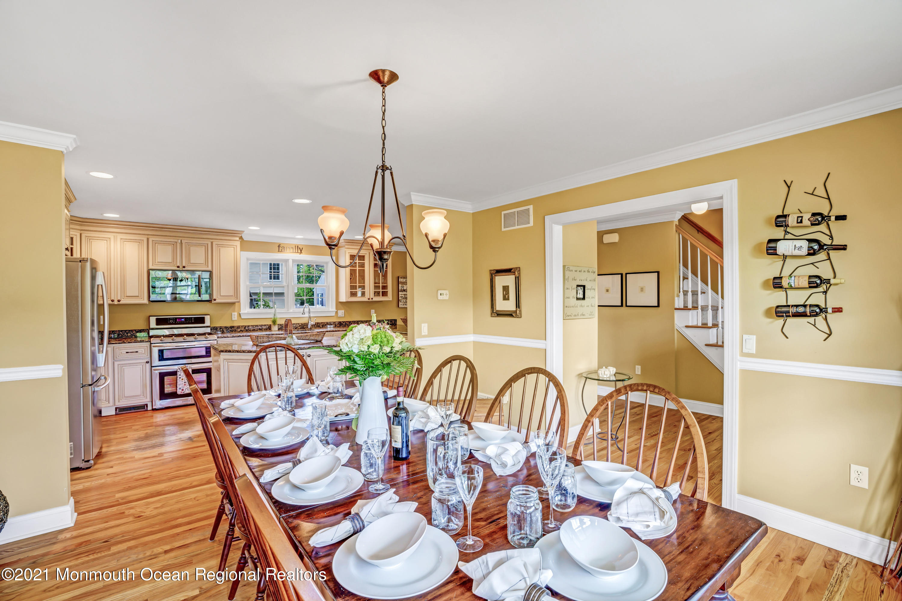 75 Minnesink Road Manasquan, NJ 08736 - Photo 14 of 53 a view of a dining room and livingroom with furniture wooden floor a chandelier