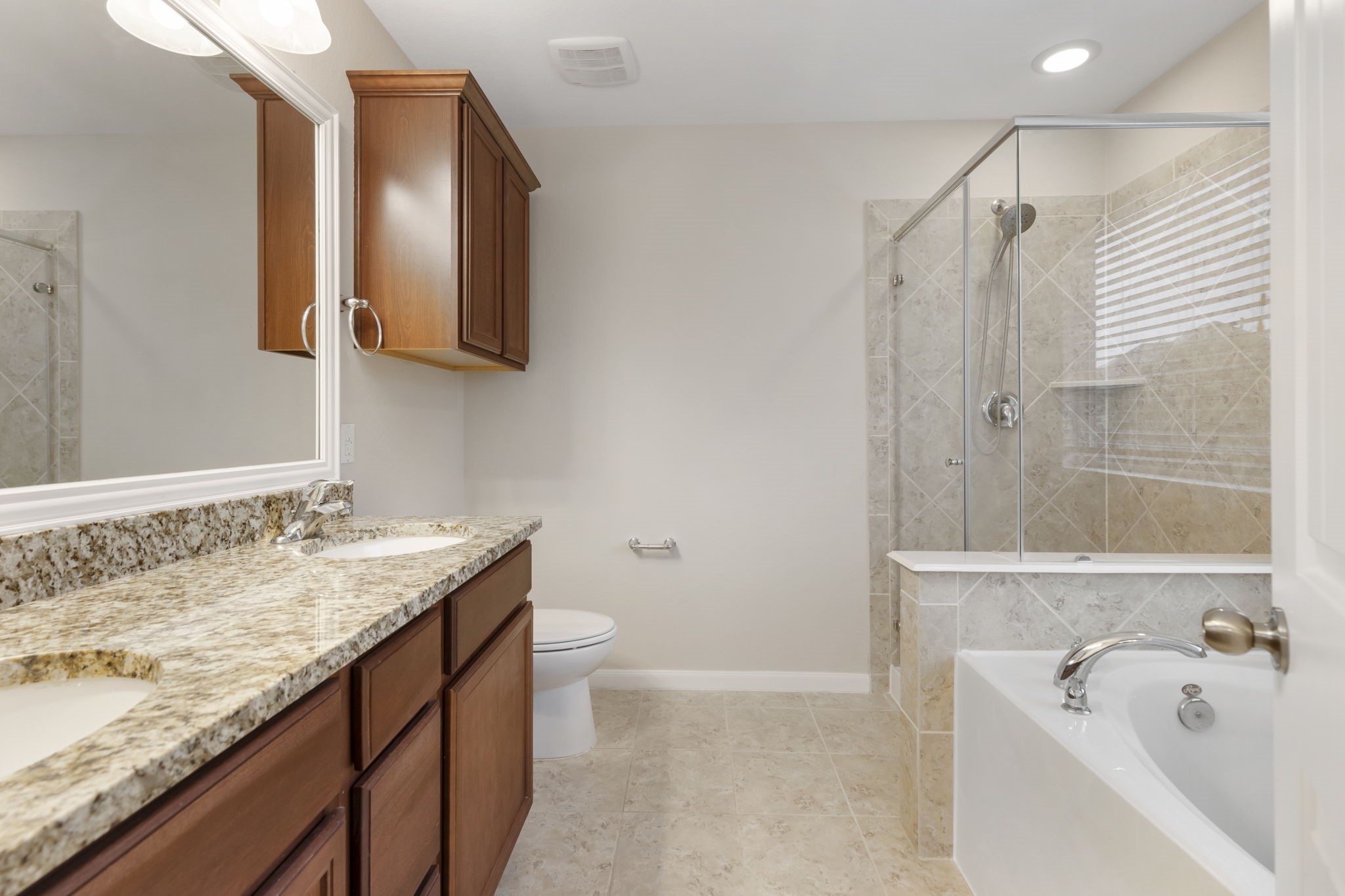 7130 Edwanna Lane Spring, TX 77389 - Photo 20 of 36 Primary bathroom boasts double sinks, granite vanity and separate shower.