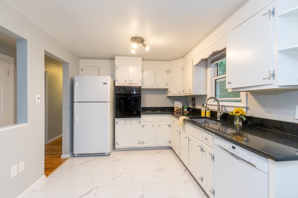 5 Ellen Road Burlington, MA 01803 - Photo 11 of 39 a kitchen with granite countertop white cabinets and refrigerator