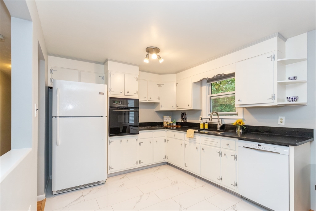 5 Ellen Road Burlington, MA 01803 - Photo 12 of 39 a kitchen with granite countertop a refrigerator a sink a stove a microwave and cabinets