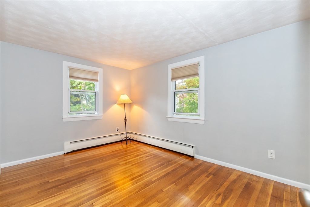 5 Ellen Road Burlington, MA 01803 - Photo 16 of 39 a view of an empty room with wooden floor and a window