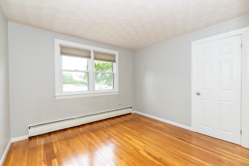 5 Ellen Road Burlington, MA 01803 - Photo 17 of 39 a view of an empty room with wooden floor and a window