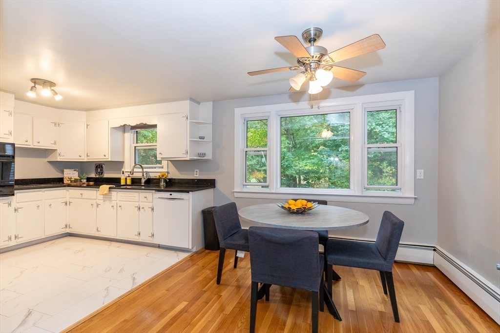 5 Ellen Road Burlington, MA 01803 - Photo 8 of 39 a kitchen with a window a dining table and chairs with wooden floor
