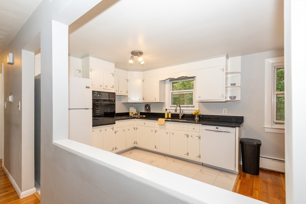 5 Ellen Road Burlington, MA 01803 - Photo 10 of 39 a large kitchen with granite countertop a sink a counter top space and stainless steel appliances