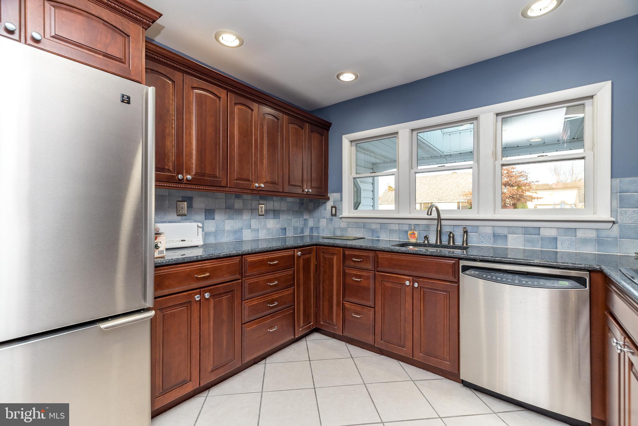 29 Hope Road Levittown, PA 19056 - Photo 11 of 49 a kitchen with stainless steel appliances granite countertop a sink and cabinets