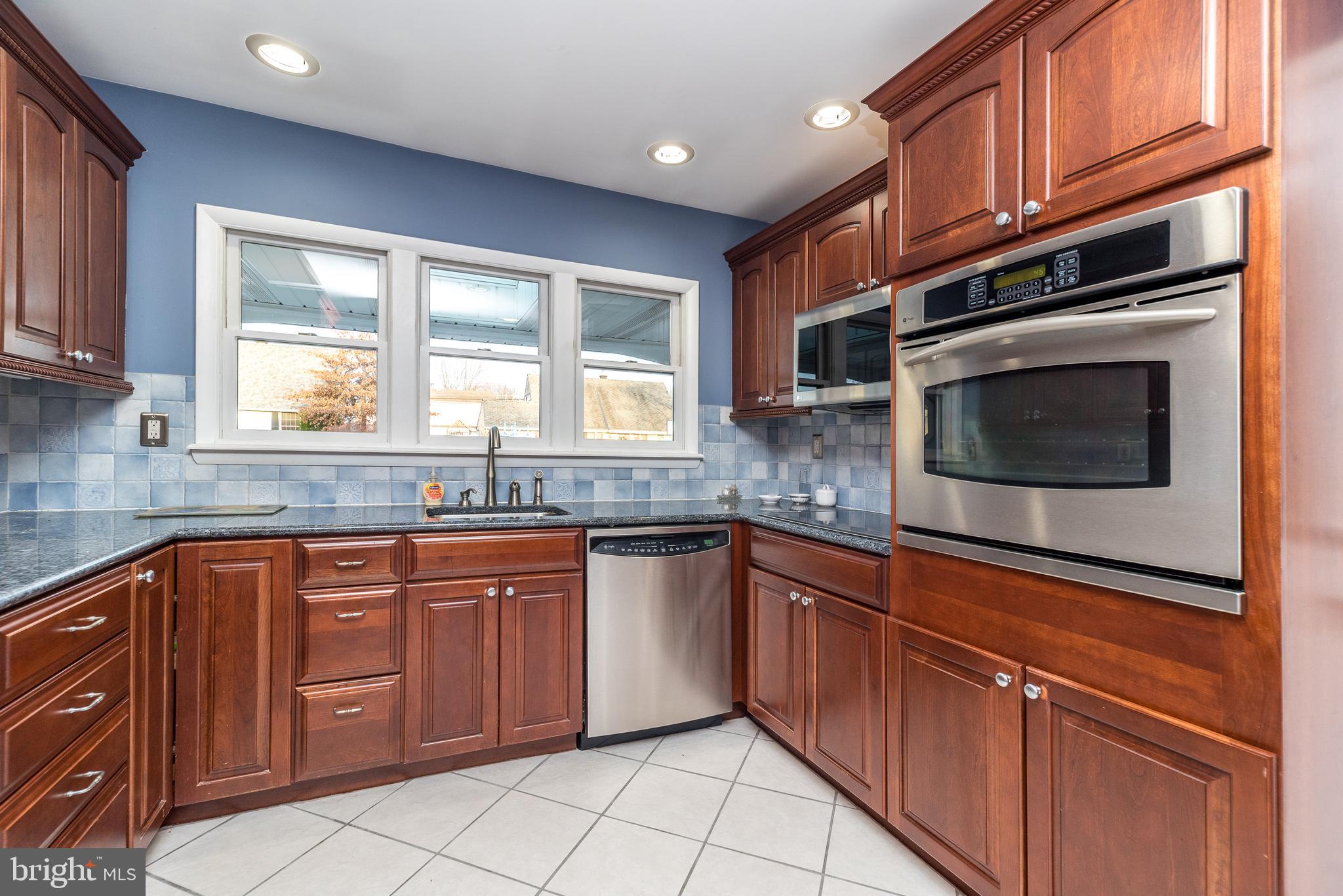 29 Hope Road Levittown, PA 19056 - Photo 12 of 49 a kitchen with stainless steel appliances granite countertop a sink and cabinets