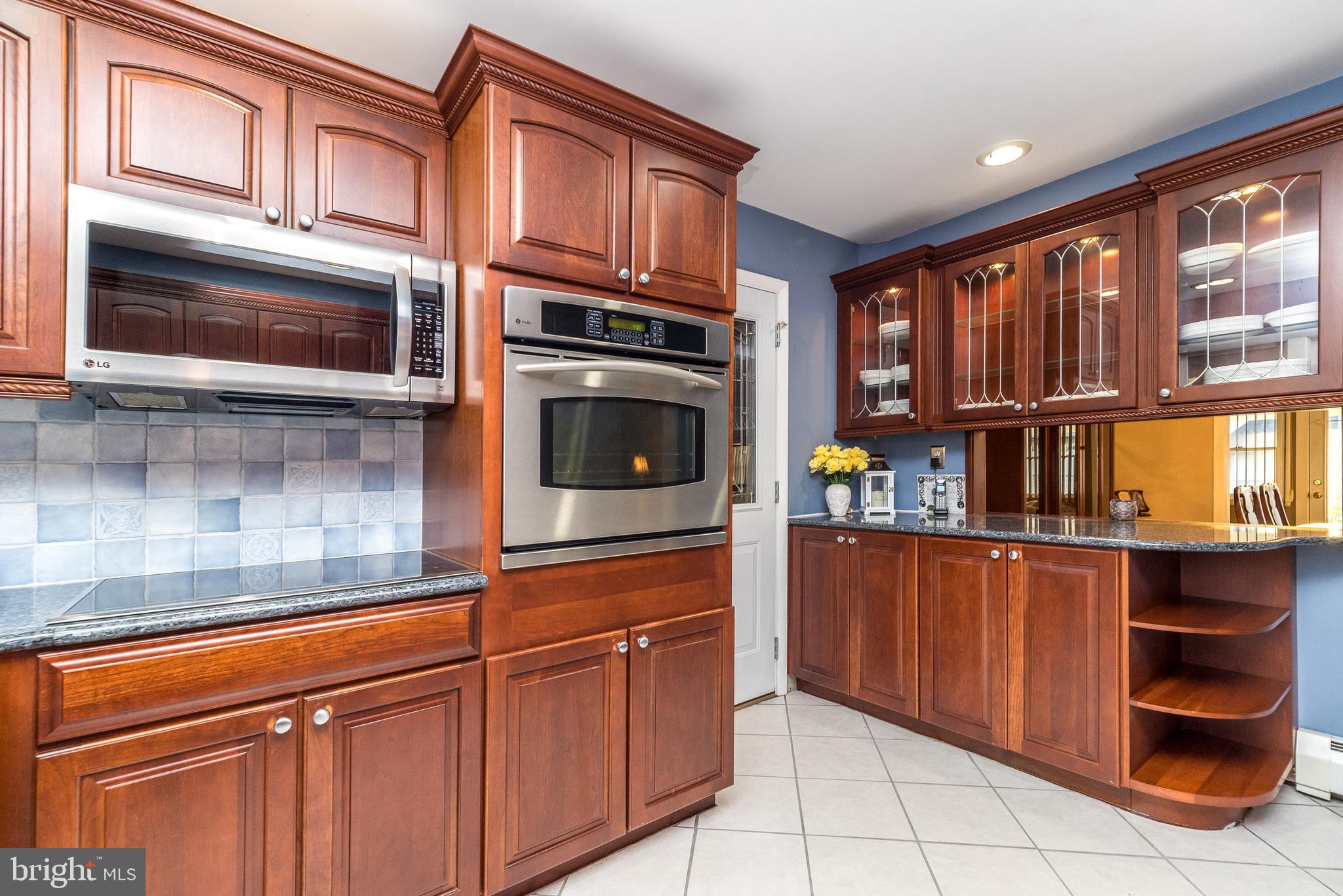 29 Hope Road Levittown, PA 19056 - Photo 13 of 49 a kitchen with stainless steel appliances granite countertop a stove and cabinets