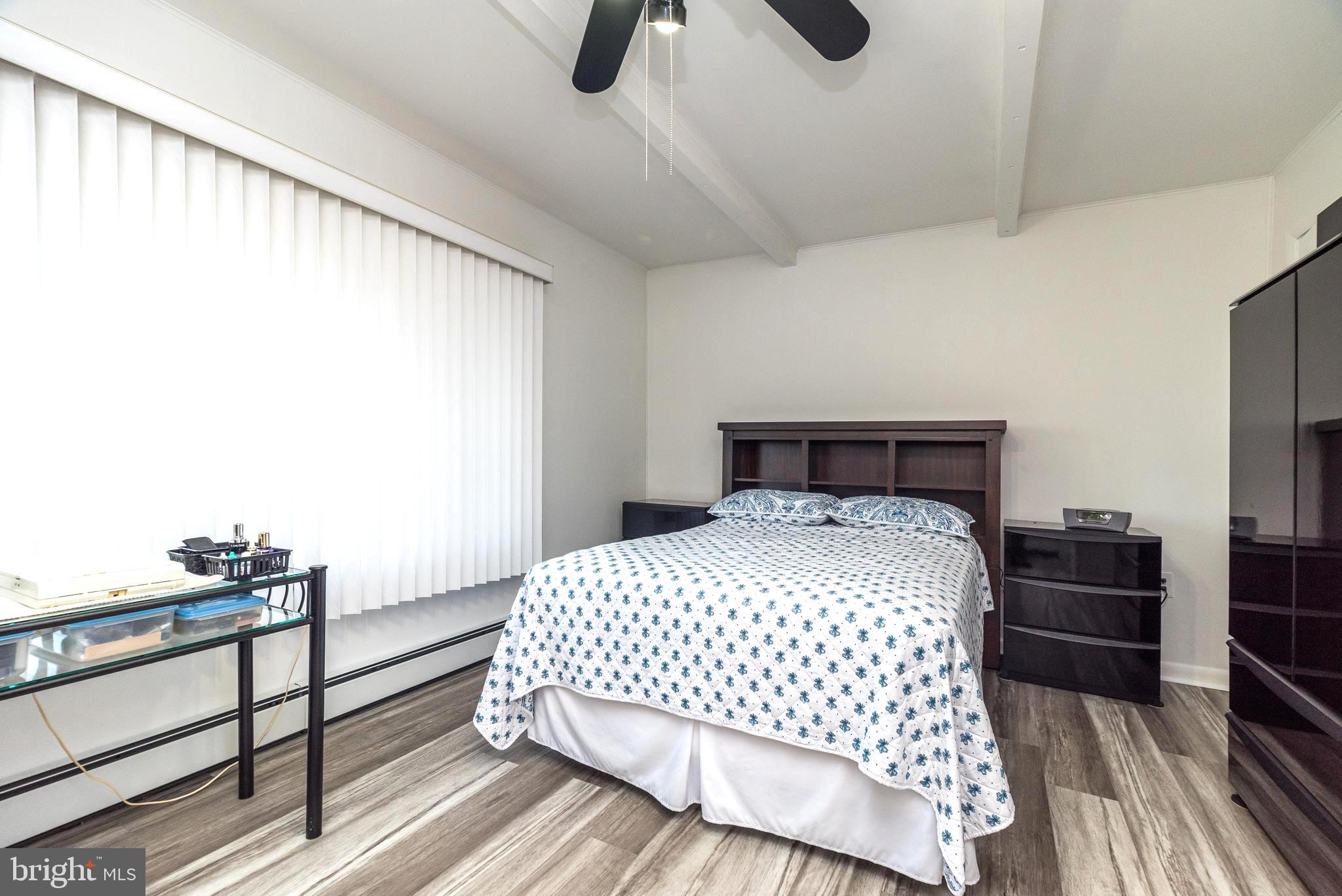 29 Hope Road Levittown, PA 19056 - Photo 29 of 49 a bedroom with a bed and wooden floor