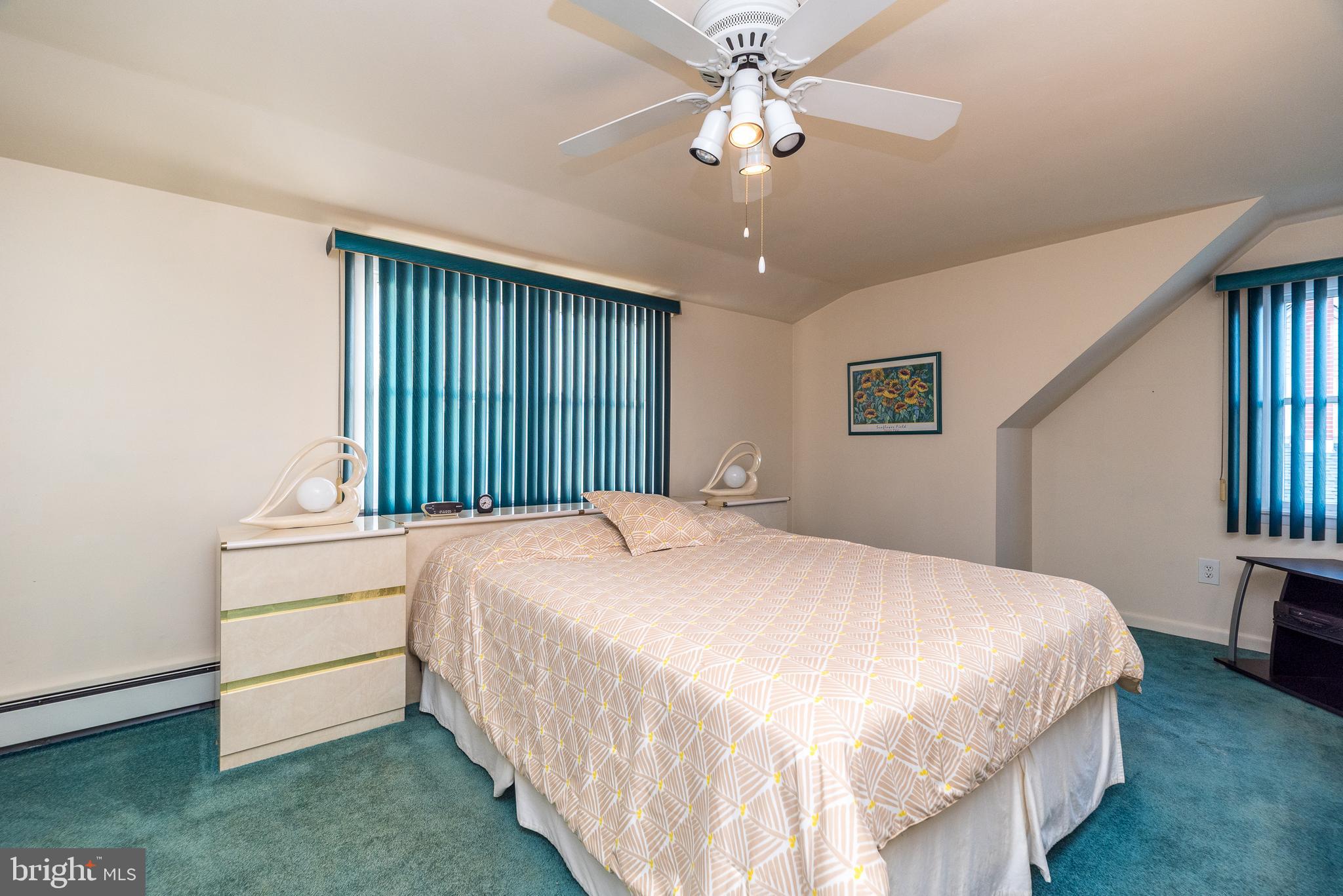 29 Hope Road Levittown, PA 19056 - Photo 35 of 49 a spacious bedroom with a bed chandelier and a window