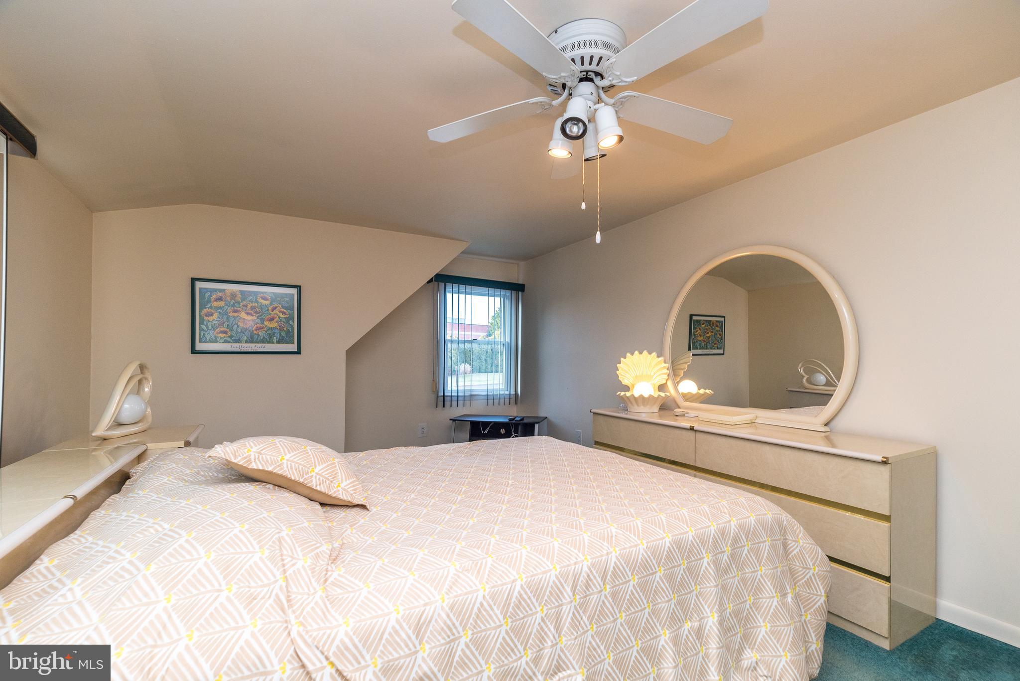 29 Hope Road Levittown, PA 19056 - Photo 37 of 49 a bedroom with a bed mirror and a ceiling fan