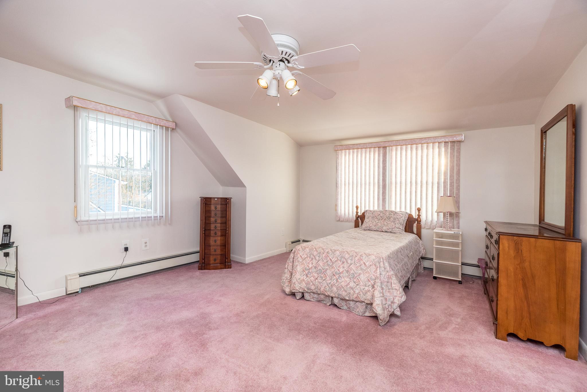 29 Hope Road Levittown, PA 19056 - Photo 38 of 49 a spacious bedroom with a bed and a chandelier