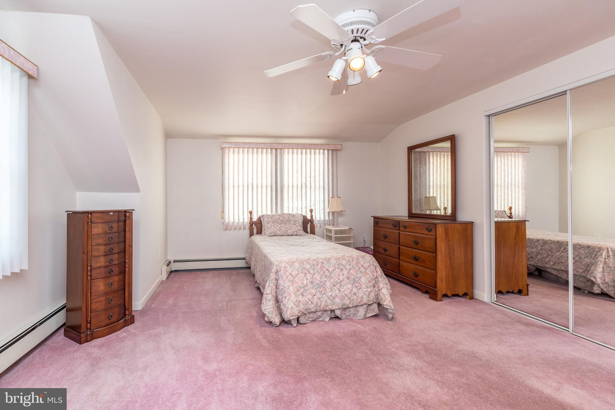 29 Hope Road Levittown, PA 19056 - Photo 39 of 49 a spacious bedroom with a bed and a chandelier