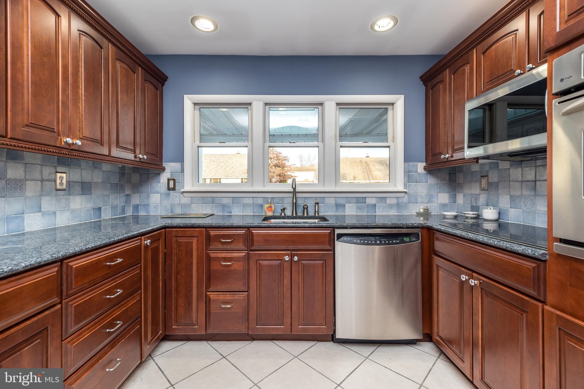 29 Hope Road Levittown, PA 19056 - Photo 10 of 49 a kitchen with stainless steel appliances granite countertop wooden cabinets and a stove top oven