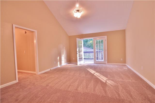 7172 Chester Road Fairview, TN 37062 - Photo 4 of 11 Another view of the great room with the newly carpeted floors and brand new French doors that lead out onto the deck.