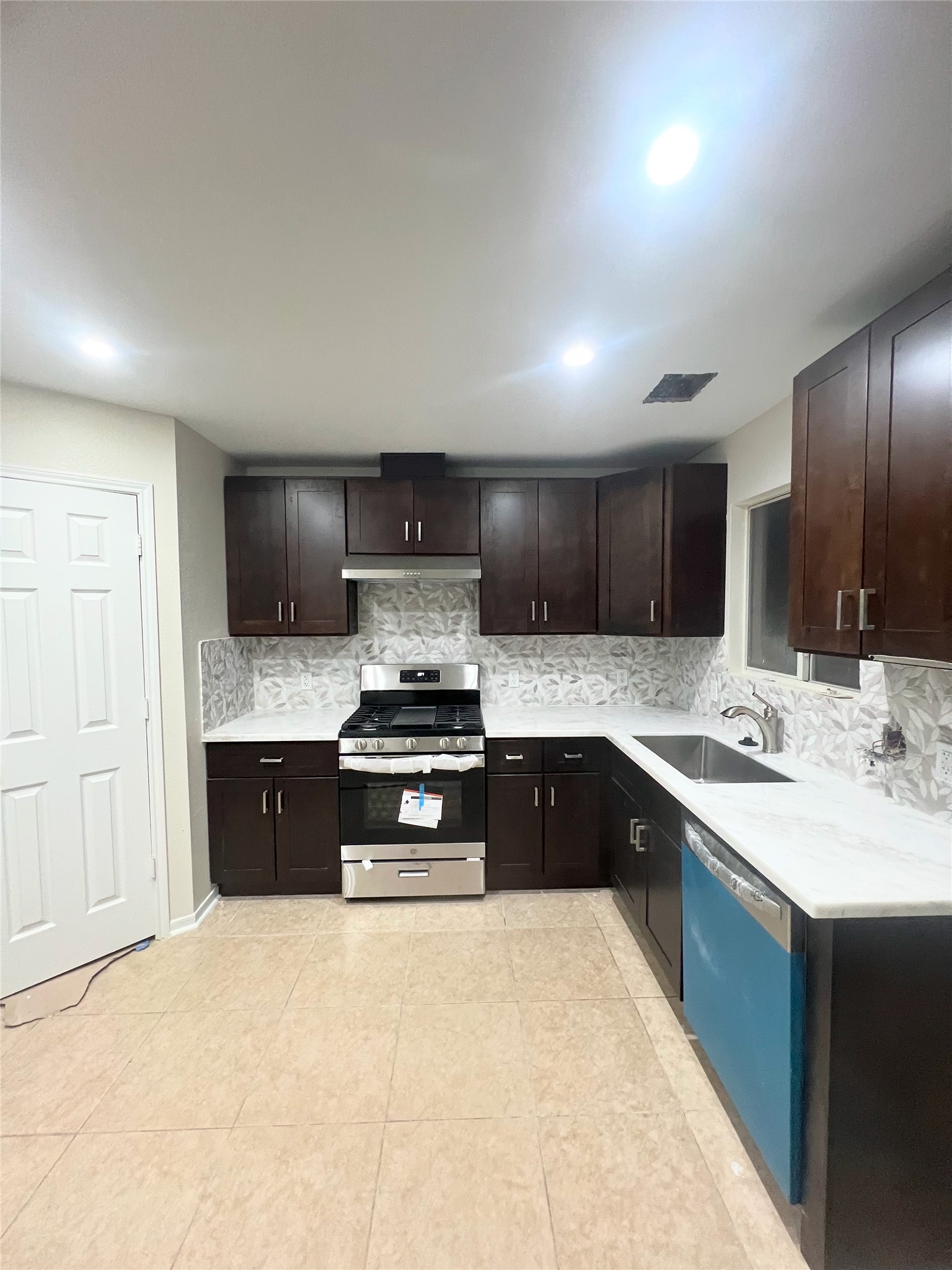 19551 Dawn Canyon Road Houston, TX 77084 - Photo 4 of 8 a kitchen with stainless steel appliances granite countertop a sink stove and refrigerator