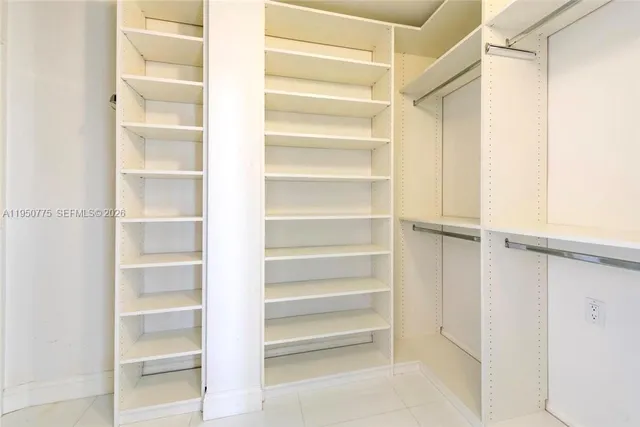 a view of walk in closet with empty racks