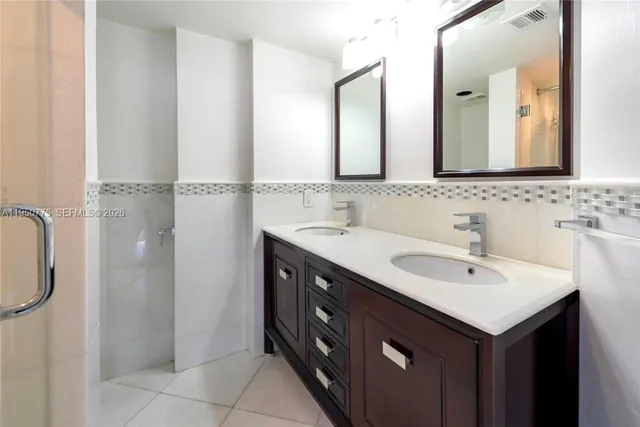 a bathroom with a double vanity sink a and mirror