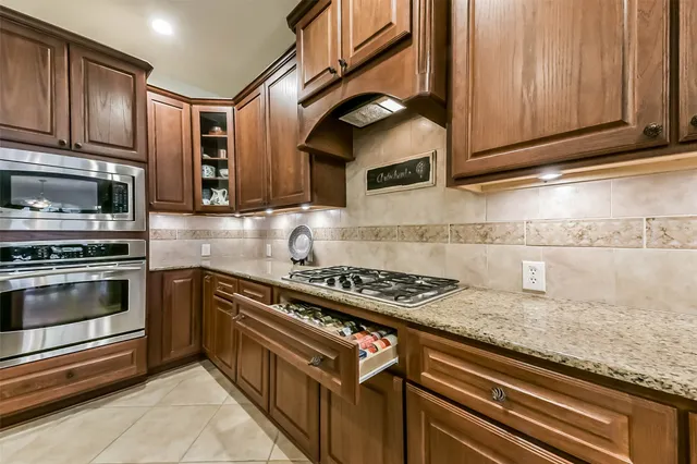 a kitchen with stainless steel appliances granite countertop a stove and a sink