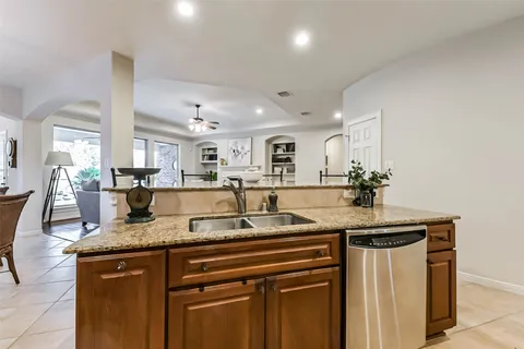 a kitchen with granite countertop a sink and cabinets