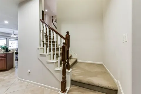a view of staircase with white walls and railing