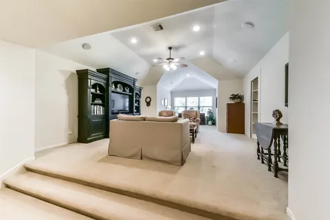 a living room with furniture and a chandelier