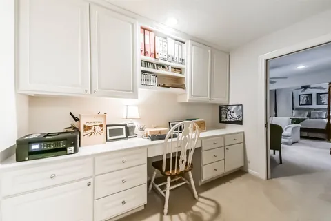 a living room with furniture ceiling fan and a window