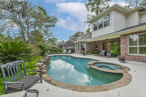 a open kitchen with stainless steel appliances granite countertop a sink a stove and a wooden cabinets