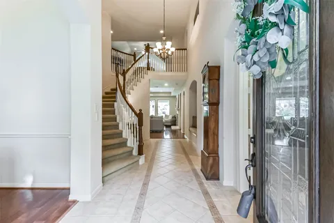 a view of a hallway with a flower pot and a chandelier