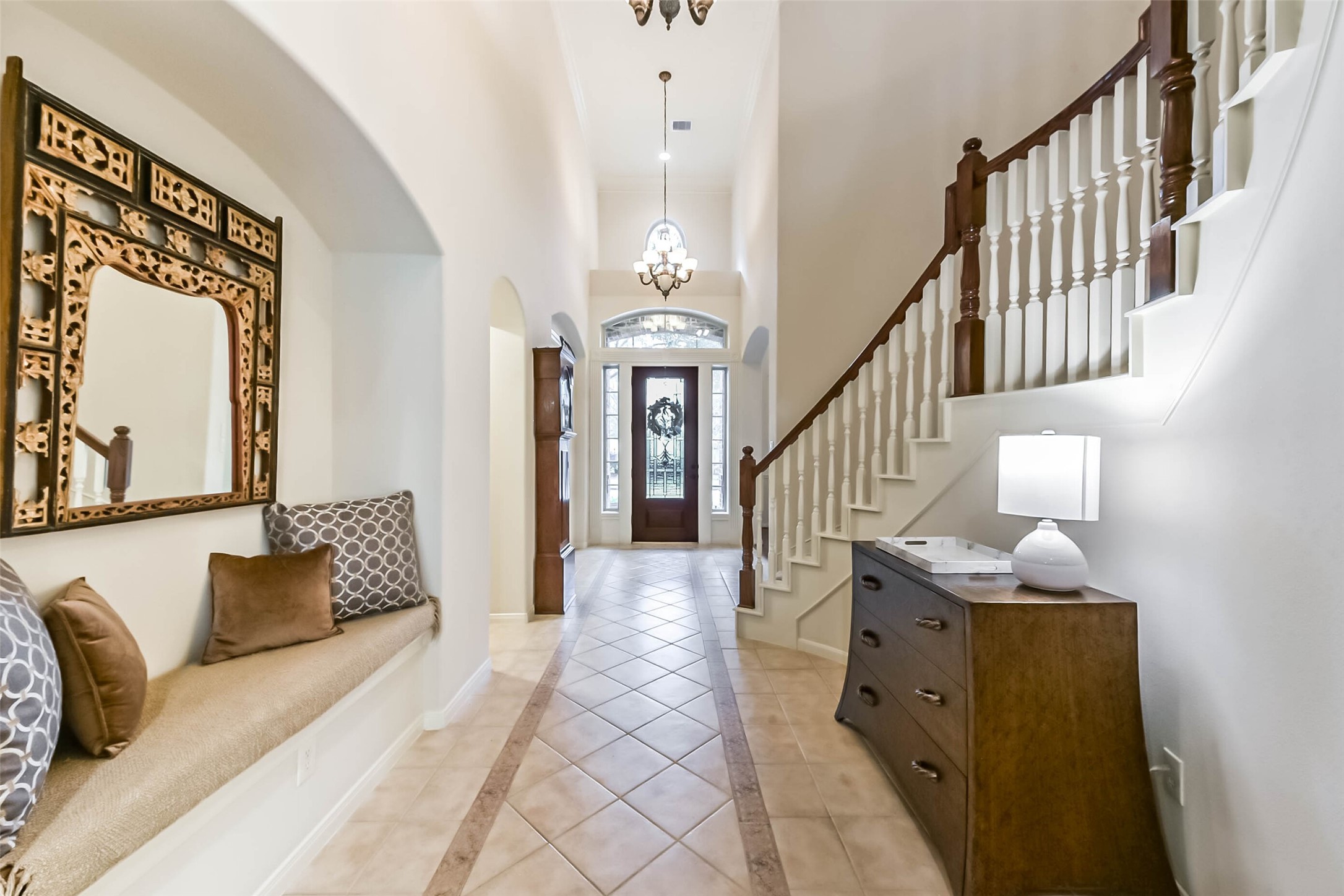 25295 Bull Ridge Drive Porter, TX 77365 - Photo 8 of 50 Welcoming entry way featuring a built-in bench niche, decorative arches, and elegant staircase