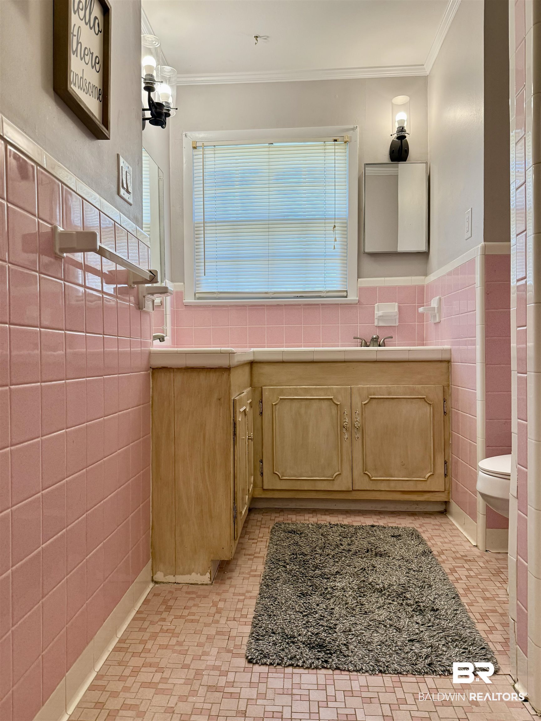 2785 Appleton Road Brewton, AL 36426 - Photo 20 of 28 Bathroom featuring vanity, tile walls, ornamental molding, a wainscoted wall, and light tile patterned floors