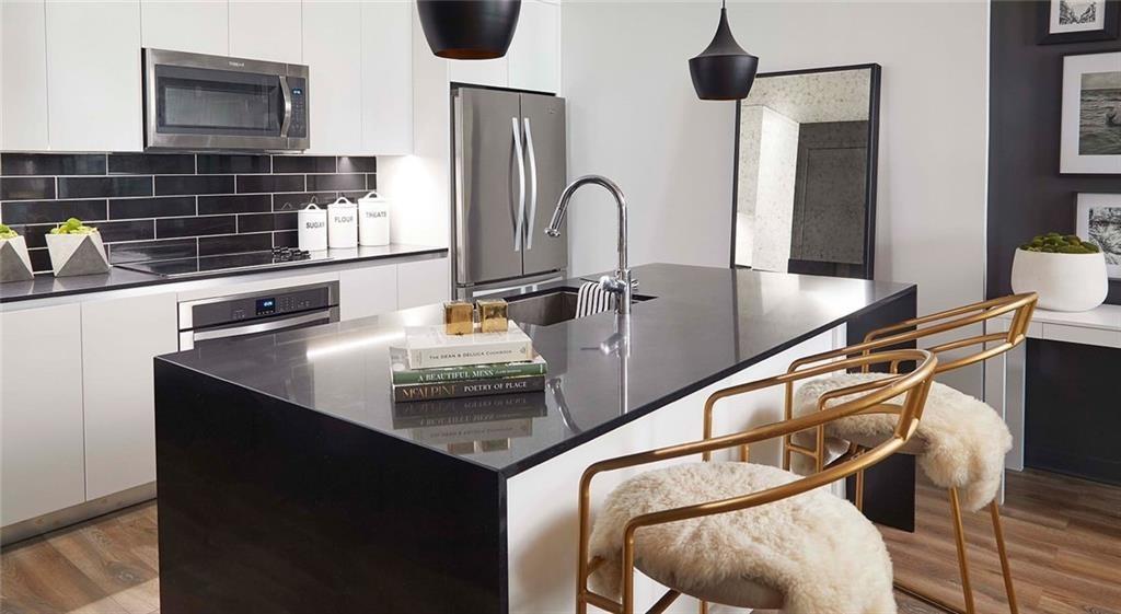 207 13th Street Northeast, Unit S2 Atlanta, GA 30309 - Photo 20 of 46 a kitchen with a table chairs and a sink