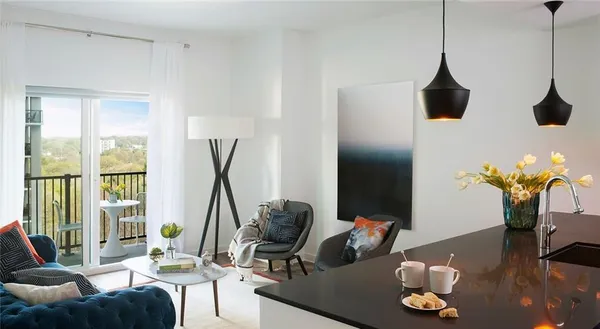 a living room with furniture and a floor to ceiling window