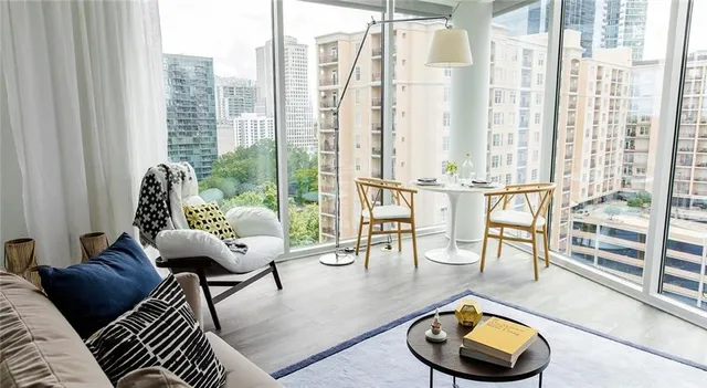 a living room with furniture and a floor to ceiling window