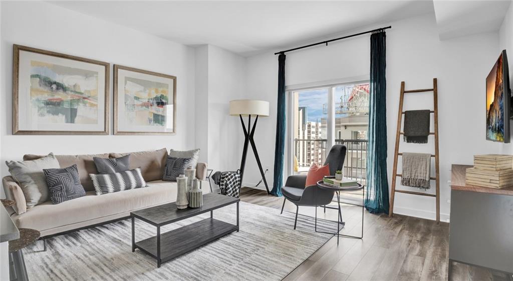 207 13th Street Northeast, Unit S2 Atlanta, GA 30309 - Photo 36 of 46 a living room with furniture a rug and a floor to ceiling window