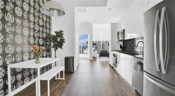 a kitchen with a refrigerator and a stove top oven