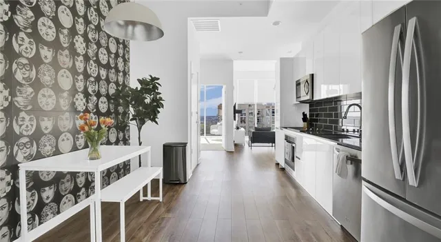 a kitchen with a refrigerator and a stove top oven