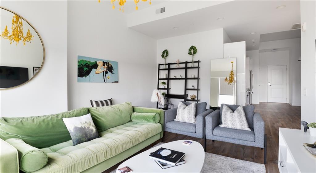 207 13th Street Northeast, Unit S2 Atlanta, GA 30309 - Photo 41 of 46 a living room with furniture and a flat screen tv