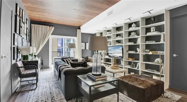 a kitchen with stainless steel appliances granite countertop a refrigerator a stove a sink and a wooden floors