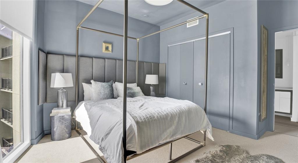 207 13th Street Northeast, Unit S2 Atlanta, GA 30309 - Photo 45 of 46 a bedroom with a bed and a walk in closet